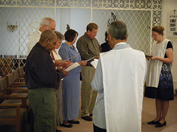 Member and then-moderator Wendy P. prays with 2010's five new novices before initiating them into the chapter.